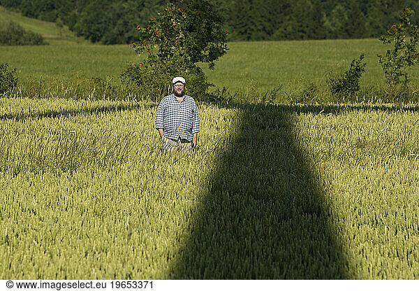 A man stands in the shadow of the Saint Elias wind turbine near the town of Vilemov in Eastern Czech Republic.
