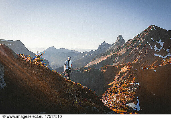 A man with a camera is walking in North Cascades