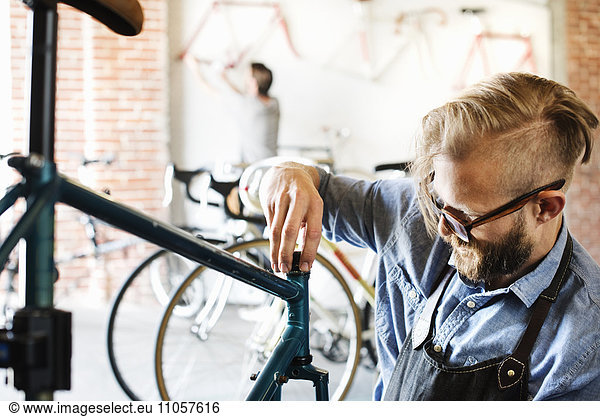 A man working in a bicycle repair shop.