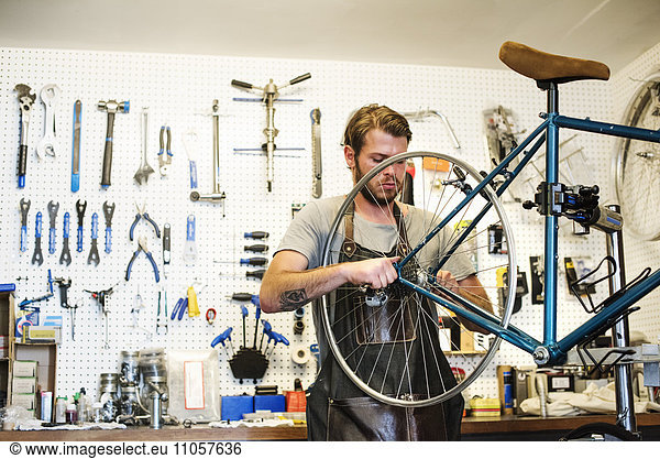 A man working in a bicycle repair shop.