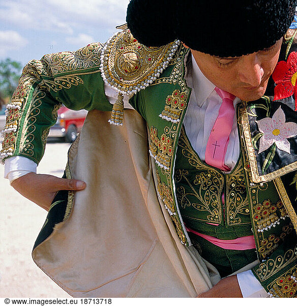 A matador wraps himself in his parade cape prior to entering the Santa Maria bullring.