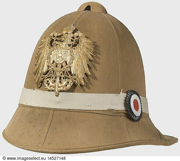 A model 1900 tropical helmet  for the infantry of the China campaign 1900 - 1903. A tropical cork helmet covered with khaki drill  and a fold-up neck shade. Green lining  leather sweatband with the manufacturer's inscription for the Bortfeldt Company  Bremen. Surrounded by a white linen band. Large imperial cockade on the right side. Gilt imperial eagle. Rare tropical helmet from the Boxer Rebellion. historic  historical  1900s  20th century  navy  naval forces  military  militaria  branch of service  branches of service  armed forces  armed service  object  objects  stills  clipping  clippings  cut out  cut-out  cut-outs  helmet  helmets  headpiece  headpieces  headgear  headgears  protection  protective  utensil  piece of equipment  utensils  uniform  uniforms