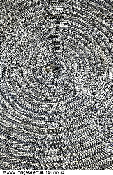 A neatly coiled line on deck of sailing yacht.