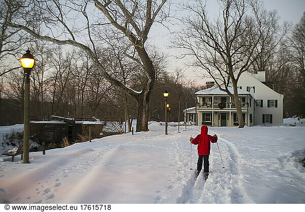 A nine year old boy cross country skis to the Great Falls Tavern.; Great Falls  Chesapeake and Ohio National Historic Park  Maryland.