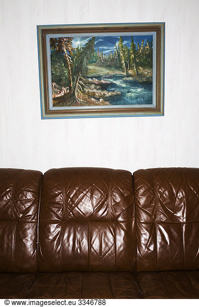A painting hanging above a couch  Sweden.