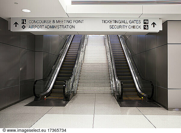 A pair of escalators and information signs