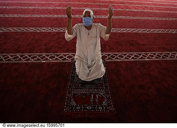 A Palestinian Muslims man pray wearing a face mask as a precaution  during Friday prayers in Southern Gaza  May 22  2020. Authorities have decided to partially reopen mosques for prayers on the last Friday in the blessed month of Ramadan nearly after two months after closure due to the Coronavirus (COVID-19).