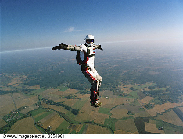 A parachute jumper in the air  Sweden.