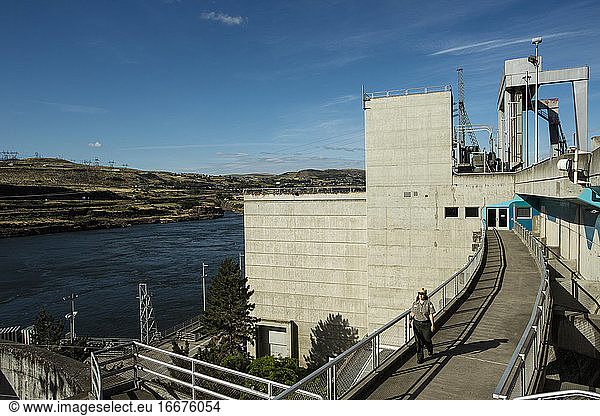 A park employee walks on the Dalles Dam in The Dalles  Oregon.
