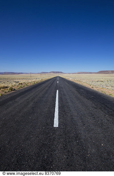 A Paved Road In A Rural Area With Blue Sky Namibia