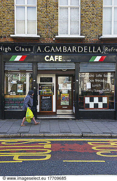 A Pedestrian Walks By A Cafe; London  England