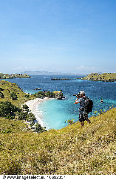 A photographer above Pink Beach in Komodo National Park  Indonesia.