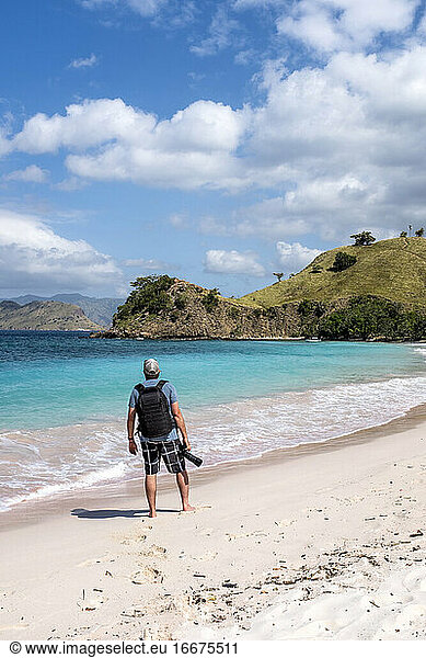 A photographer on Pink Beach in Komodo National Park  Indonesia.