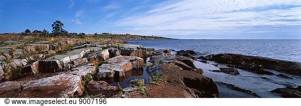 A picturesque archipelago consists of 50 islands and is located in the northern part of the Ladoga lake. There is an ancient monastery there. Valaam is also famous for various cultural natural objects: gardens  parks  avenues. In the picture: stone 'embankment' of the island Goly ('naked').