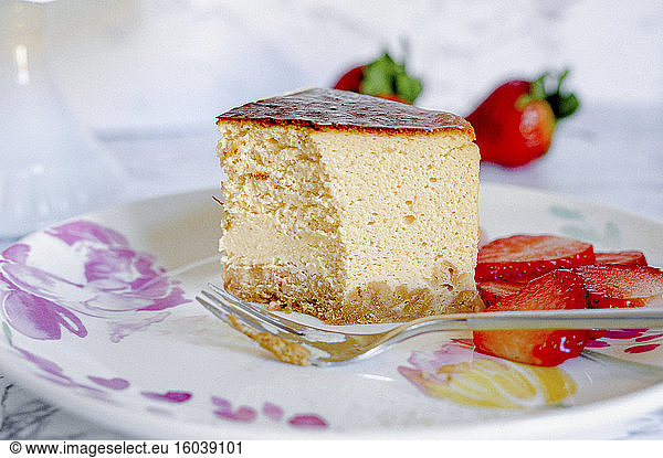 A piece of amarula cream cheese cake with strawberries