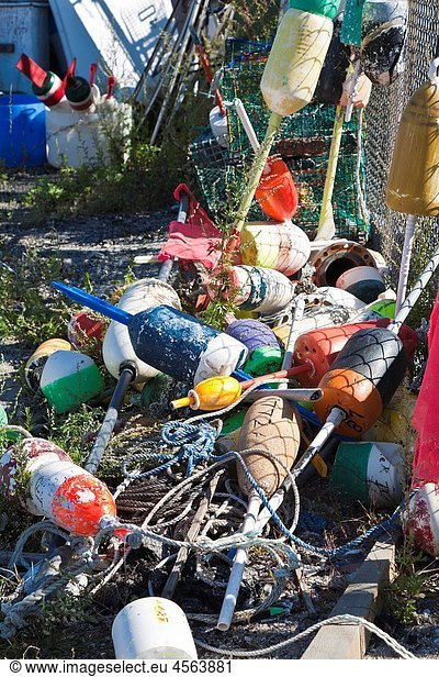 A pile of lobster bouys on a dock in Portland  Maine