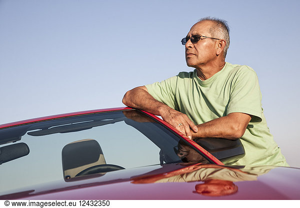 A portrait of a hip senior Hispanic male on a road trip.