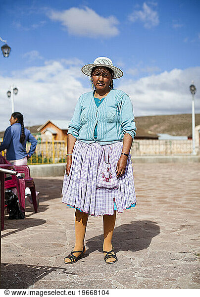 A portrait of a woman in a plaza in rural Bolivia.