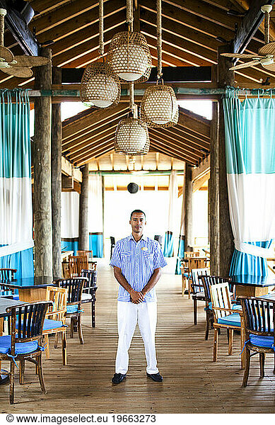A portrait of an employee at a beach restaurant and resort.