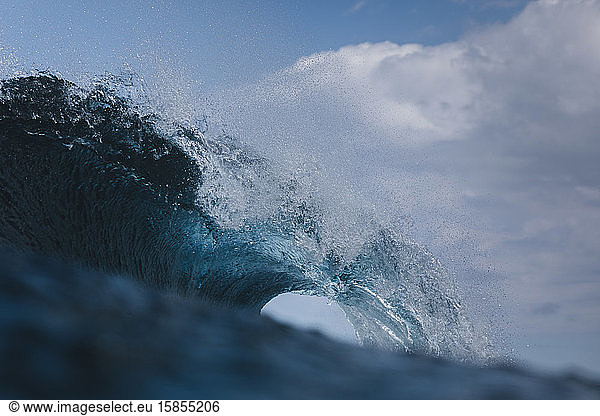 A powerful wave breaks under a cloudy sky in Gran Canaria  Spain.