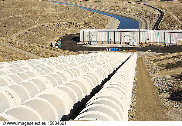 A pumping station sends water uphill over the mountains on the California aquaduct that brings water from snowmelt in the Sierra Nevada mountains to farmland in the Central Valley. Following