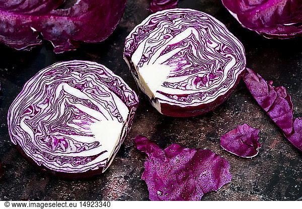A raw round red cabbage  cut across the middle.