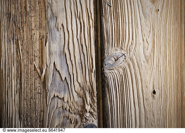 A reclaimed lumber workshop. Close up of two planks of wood  with knots and wood grain patterns.