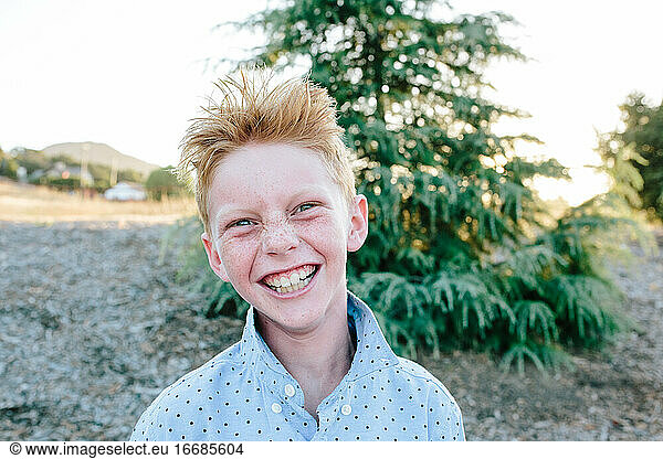 A Red Headed Boy With Freckles Smiling A Crazy Smile