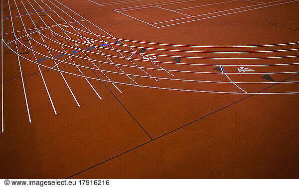 A red running track  athletics ground  a corner section of track marked with lanes