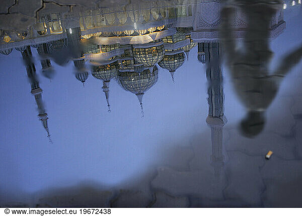 A reflection of the Crystal Mosque in a puddle at dusk  Kuala Terengganu  Terengganu  Malaysia.