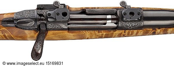 A repeating Stutzen (carbine) Grois  in Neumarkt  Austria Cal. 8 x 57 IS  no. G.G. 17707. Austrian proof mark. Bright bore  length 52 cm. Mauser 98 system. Modified lock with safety on the side. Curved bolt handle. French hair trigger. Action  lock  magazine well with cover and tangent sight blocks engraved with tendrils and silver lines. On magazine well cover sculpturally portrayed: two wild boars. Full stock made of light maple wood  darkly grained. Black muzzle ending and pistol grip cap. Bavarian cheek-piece. Insert-mounted scope Kahles Helia CT 3 - 10 x 50  reticule 4. Comes with extra Meopta Meostar R1 - 4 x 22 RD. Test target. De luxe weapon in an extraordinary design. Erwerbsscheinpflichtig. historic  historical  hunting weapon  hunting weapons  modern  weapons  arms  weapon  arm  rifle  gun  rifles  guns  firearm  fire arm  gun  fire arms  firearms  guns  object  objects  stills  clipping  clippings  cut out  cut-out  cut-outs  20th century