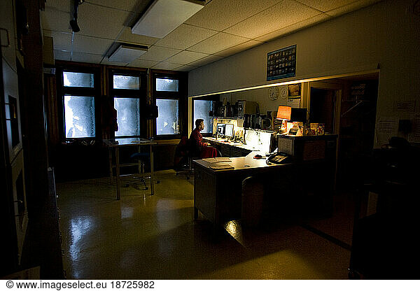 A researcher works on a computer inside the Mount Washington Observatory during the winter educational program.