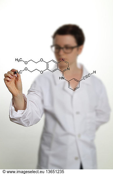 A researcher writes out the formula for erlotinib. Erlotinib is an anticancer drug effective against small cell lung cancer pancreatic cancer and other cancers in which epidermal growth factor receptor (EGFR) is overexpressed.