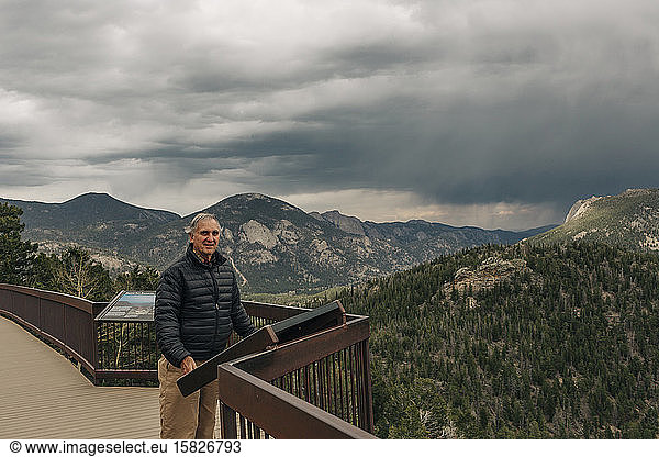 A retired man enjoys an overlook in Rocky Mountain National Park  CO.