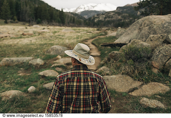 A retired man walks along a trail in Rocky Mountain National Park  CO.