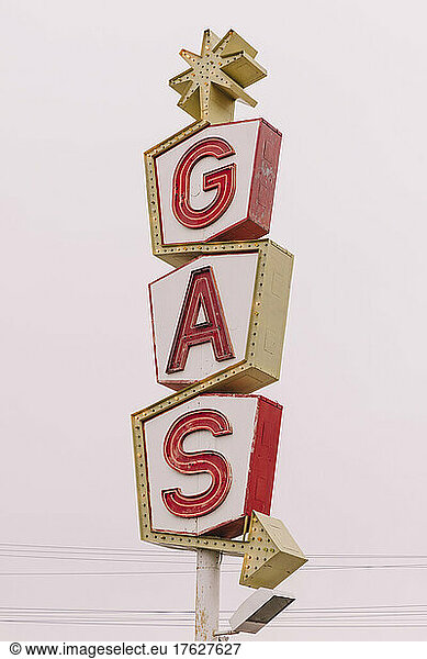 A retro style GAS station sign  red lettering road sign.