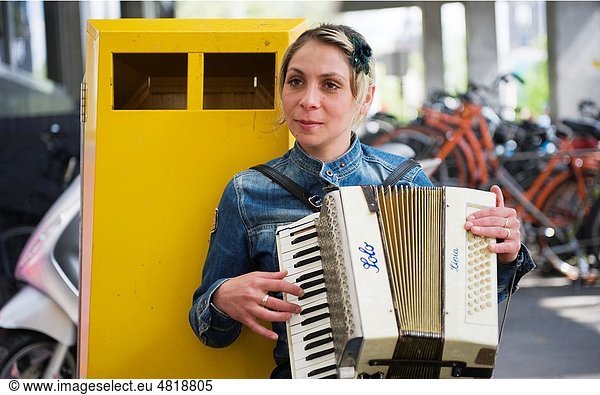 A Romanian woman plays the accordion in the streets of Utrecht  Netherlands