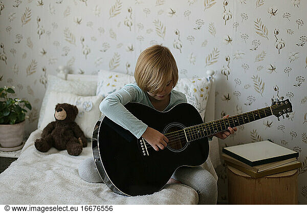 A Russian girl plays a musical instrument in her room.