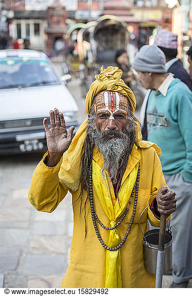 A sadhu  a Hindu holy man  pauses on a street in Kathmandu  Nepal.