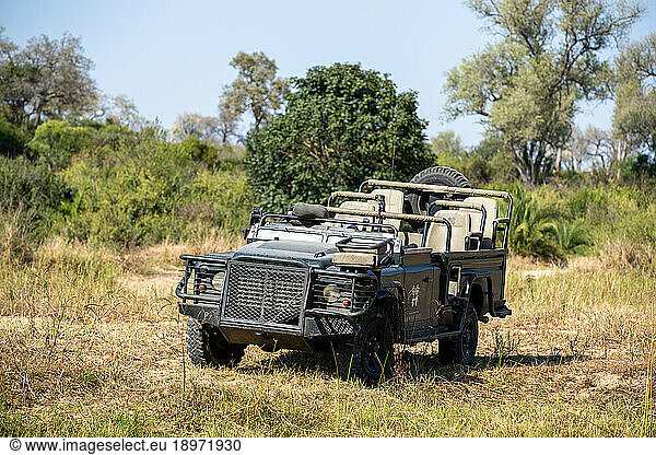 A safari vehicle  parked in the African wilderness.