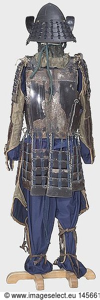 A sendai do tosei gusoku (suit of armour) made up of pieces of various sets  Japan  early to mid Edo period. Eight-plate toppai kabuto with five-lame hineno shikoro in kon ito sukage binding. Rindo maidate worked in sukashi. On the leather covered fukigaeshi an Ishidatami mon. The helmet bowl reworked and with European lacquer. Strongly damaged Nara-type leather mempo  four-lame yodare kake. Gomei sendai do in solid bullet-proof version with seven-fold kusazuri in hana iro sugake binding. Tekko kohire  the giyuyo with hinge mounting. Chest and giyuyo bearing the gold lacquered mon of the Rindo clan. Iyo haidate of iron and kusari  black lacquer. Matching shinogote and shino suneate of fawn coloured cloth. A pair of black lacquered chu sode with kon ito sugake binding. Including a pair of straw sandals. All metal parts with partially heavy lacquer damages. historic  historical  18th century  17th century  Japanese  Asian  Asia  Far East  object  objects  stills  clipping  clippings  cut out  cut-out  cut-outs