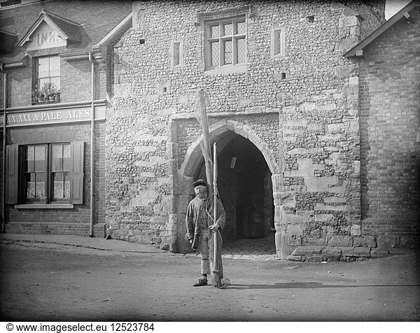 A shrimper with his equipment standing in front of Old Fishers Gate  Sandwich  Kent  c1860-c1922. Artist: Henry Taunt