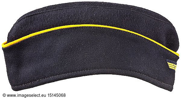 A side cap for naval female auxiliaries Depot piece in navy-blue woollen cloth in the on-board cap cut  continuous yellow wool braid  black inner liner with depot stamping  BeVo weave cap eagle (golden-yellow on dark blue ground). historic  historical  navy  naval forces  military  militaria  branch of service  branches of service  armed forces  armed service  object  objects  stills  clipping  clippings  cut out  cut-out  cut-outs  20th century
