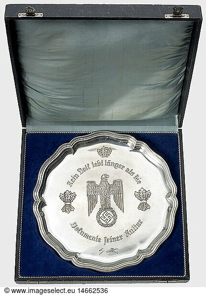 A silver presentation bowl.  Rose-bordered plate with the heraldic eagle  oak leaf bundles  and the inscription  'Kein Volk lebt länger als die Dokumente seiner Kultur' (No people lives longer than the documents of its culture) along with a facsimile signature of Adolf Hitler engraved in the centre. The silversmith's mark 'Wellner' and the hallmark '800' on the back. Weight 521 g. Diameter 30 cm. It comes with the certificate awarding the title of professor (envelope with punch-holes) to the Senior Administrative Councilor  Dr. Berthold Widmann  Reich's Commissar at the Prize Court of Appeals  Berlin. Meissner's signature 1943. Also a congratulatory telegram from Grand Admiral Raeder  and a newspaper clipping. historic  historical  1930s  20th century  navy  naval forces  military  militaria  branch of service  branches of service  armed forces  armed service  object  objects  stills  clipping  clippings  cut out  cut-out  cut-outs