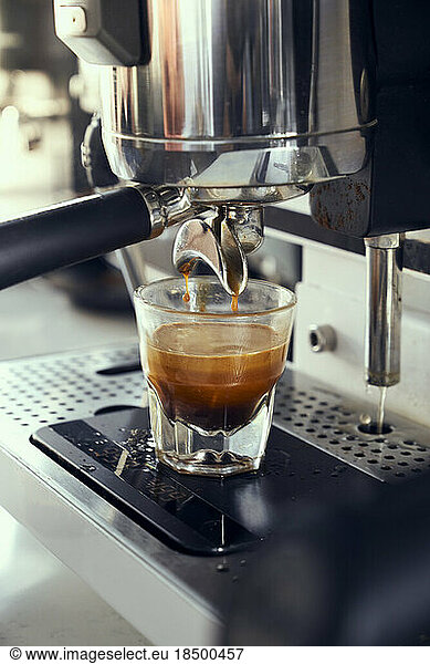 A single espresso shot being pulled from an espresso machine.