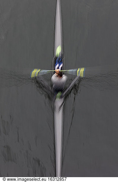 A single scull boat and rower on the water  view from above. Motion blur