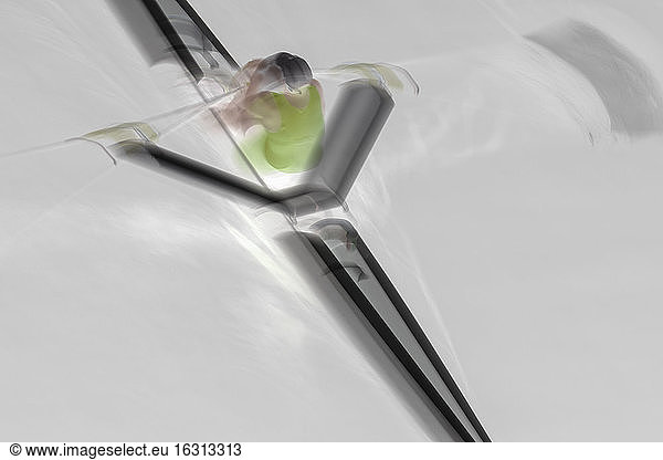 A single scull boat and rower on the water  view from above. Motion blur