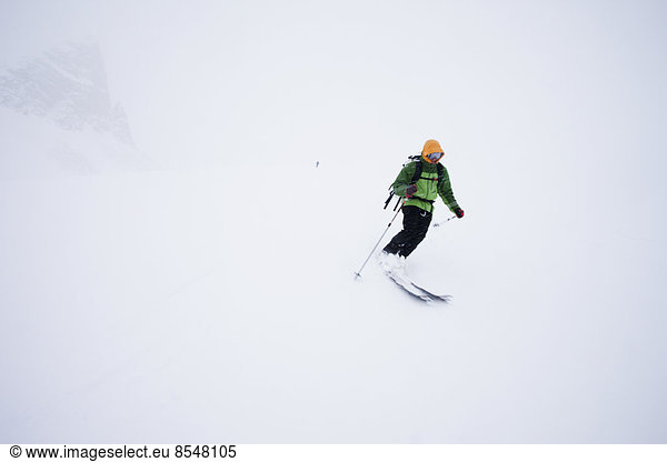 A skier in powder snow in mist and cloud conditions on the Wapta Traverse,  a mountain hut to hut ski tour in Alberta,  Canada.