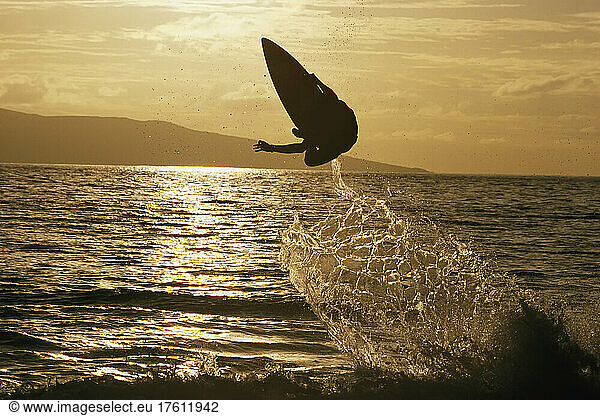 A skimboarder launches into the air in Maui.; Maui  Hawaii.