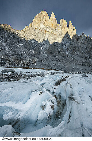A small river winds its way down the Torre Glacier  with Fitzroy